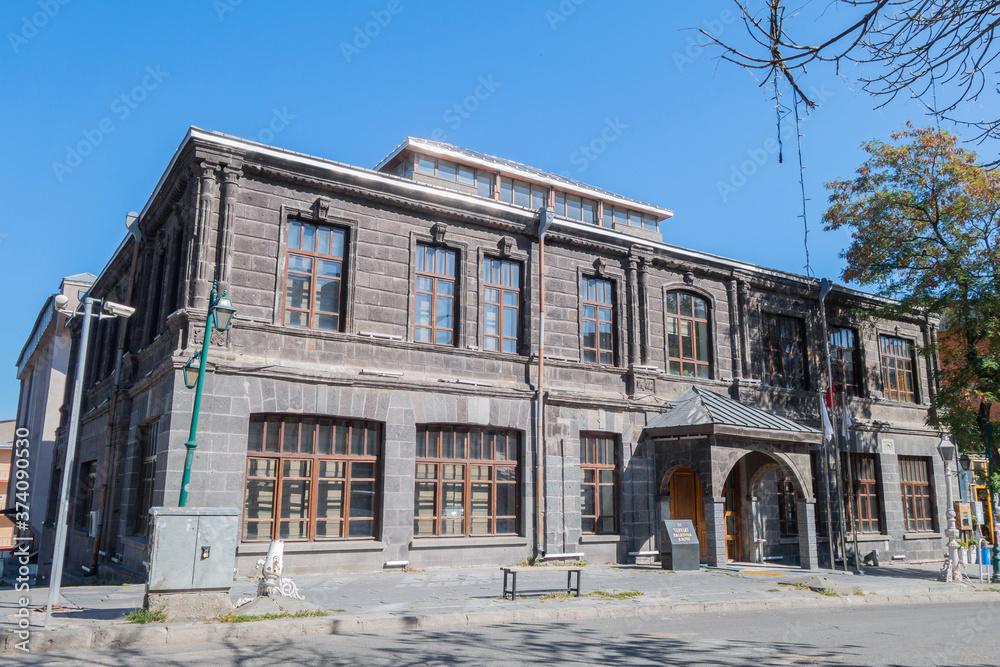 Street view onto historic building in Kars, Turkey. Building are in Baltic style. Writing on small stone pillar (front of building) translates as 'Serhat Development Agency' (Serhat is Turkish name)