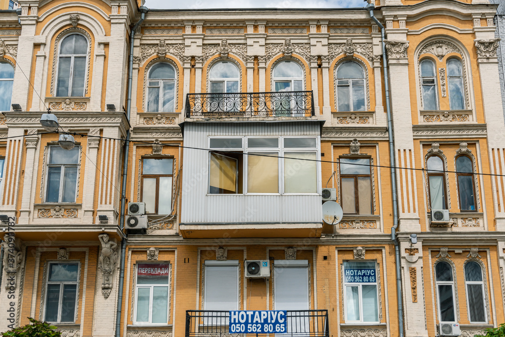 Kyiv (Kiev), Ukraine - August 08, 2020: An ugly plastic balcony on a pre-revolutionary building which spoils original architecture