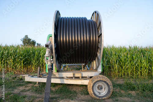 irrigation reel by the side of a maize field in france