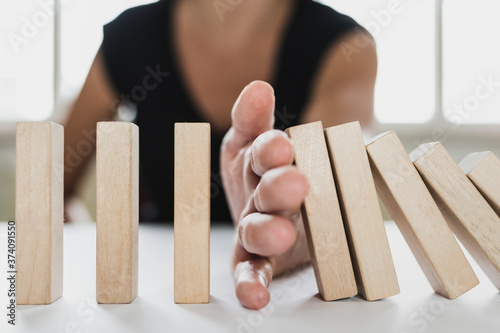 Business mediator stopping falling wooden dominos with hand dispute settlement mediation consultant advisor solving conflicts problems