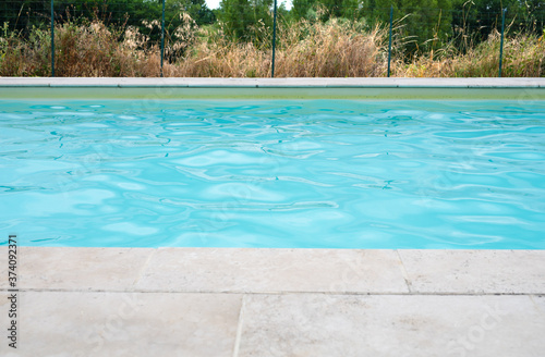 Section of swimming pool with stone surround
