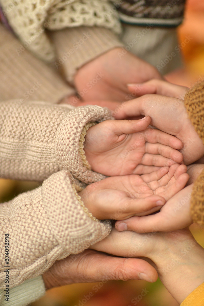 Cropped image, family putting hands together close up Cropped image, family putting hands together close up