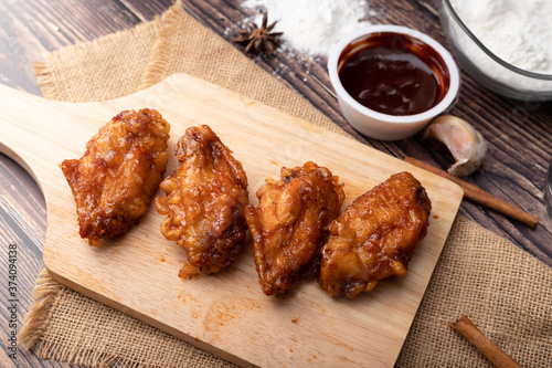 Hot and spicy Korean barbeque fried chicken on wood cutting board
