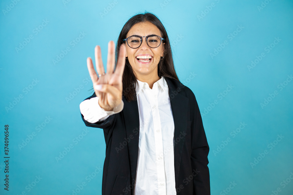 Young beautiful business woman over isolated blue background showing and pointing up with fingers number four while smiling confident and happy Young beautiful business woman over isolated blue background showing and pointing up with fingers number four while smiling confident and happy