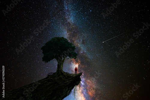 Man under a tree in front of the universe фототапет