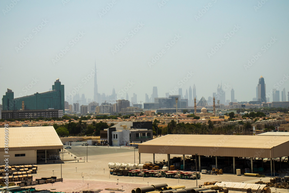 Naklejka premium View of not a usual Dubai's skyline with warehouse on foreground. UAE.