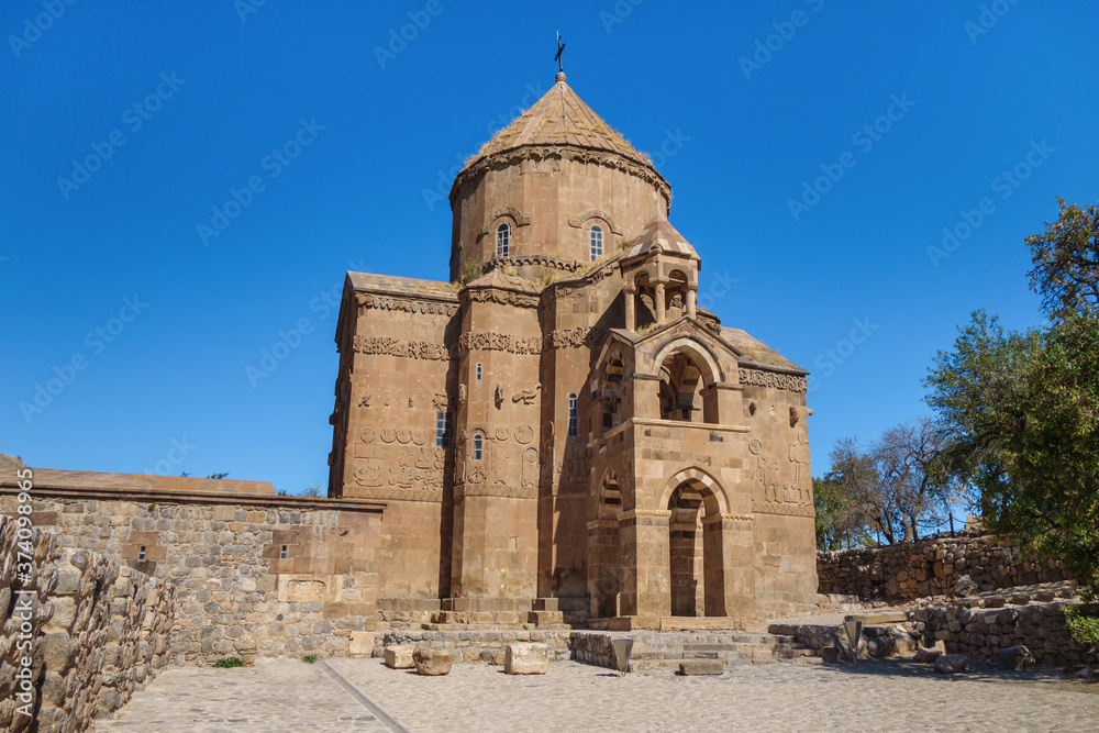 Main facade of medieval Armenian Cathedral of Holy Cross & empty square in front of it, Akdamar island, Van Lake, Gevaş, Turkey. Built in 921, it's still masterpiece among many christian churches