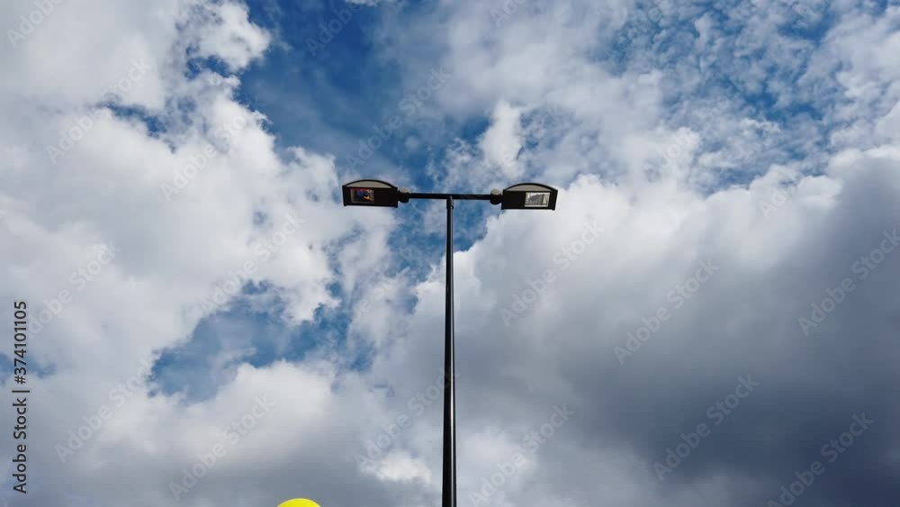 yellow inflatable balloon moving around streetlamp outdoors yellow inflatable balloon moving around streetlamp outdoors