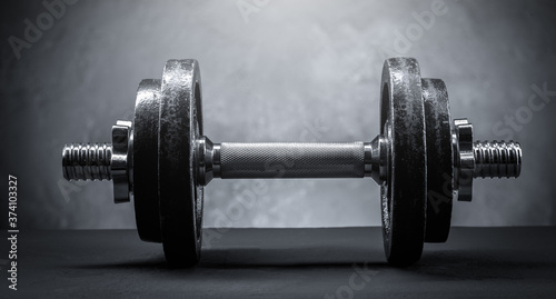 sports dumbbell on a dark background