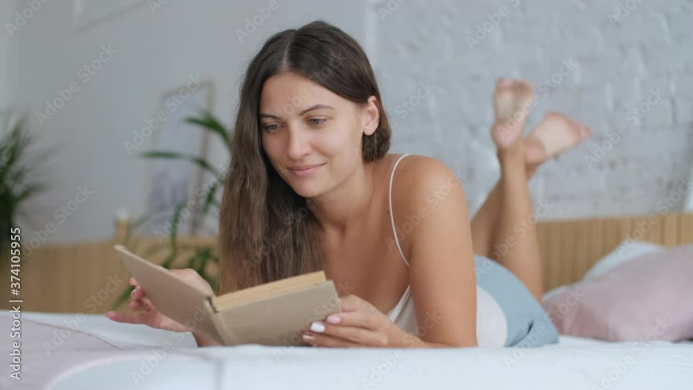 Leisure at home, Stay in the house, Beautiful woman, home weekend. Attractive Woman Lying on Bed in Bedroom and Reading Book Leisure at home, Stay in the house, Beautiful woman, home weekend. Attractive Woman Lying on Bed in Bedroom and Reading Book