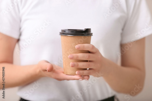 Woman holding disposable co...