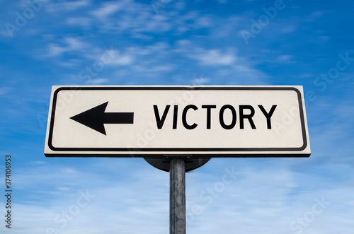 Victory road sign, arrow on blue sky background. One way blank road sign with copy space. Arrow on a pole pointing in one direction.