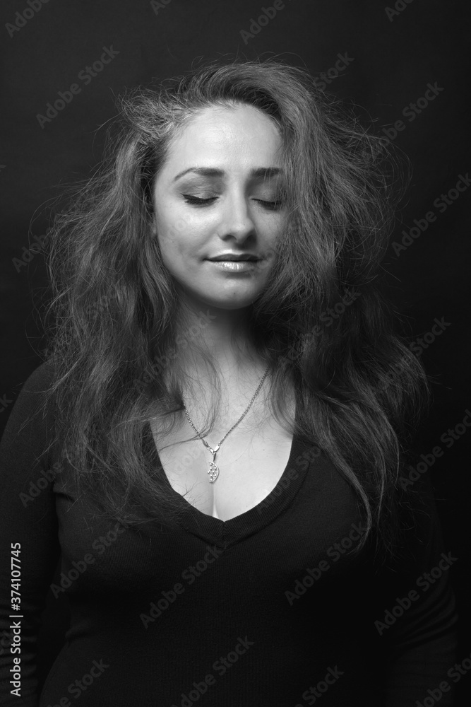 The beautiful smiling woman with closed eyes The beautiful smiling woman with closed eyes
