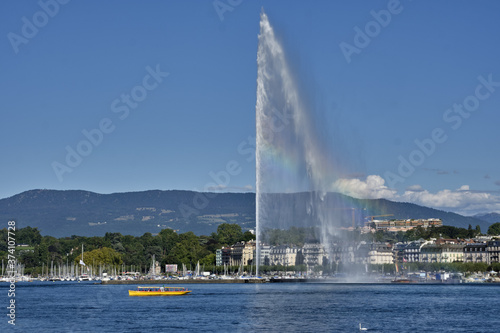 the water jet fountain and the famous yellow boats on, lake geneva, switzerland. © hectorchristiaen