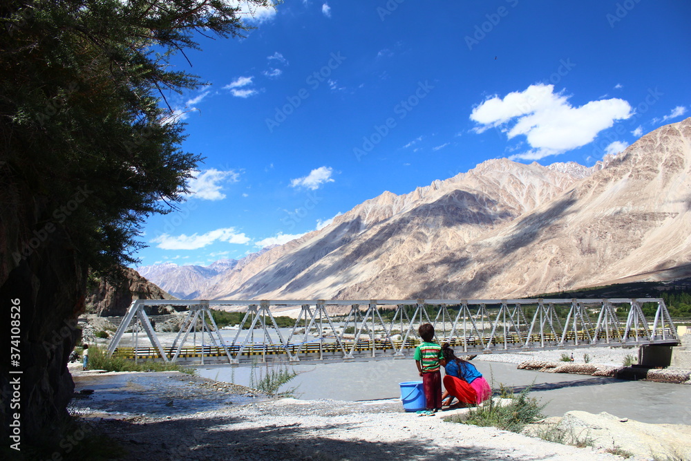 people washing clothes by hands in the mountains Tibet