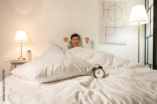 Stressed man with alarm clo...