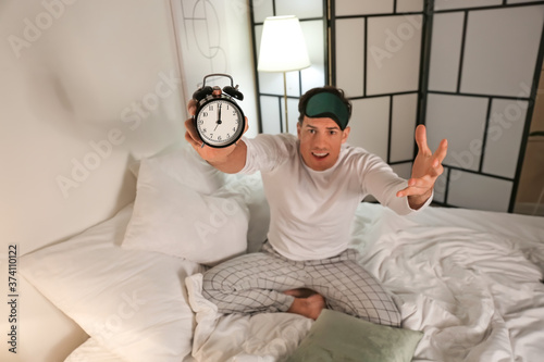 Stressed man with alarm clo...