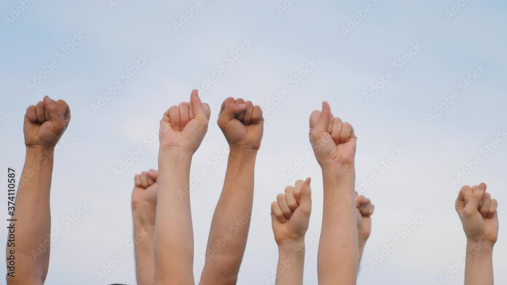 Teamwork. A group of people against the sky raises their hands up. The concept of voluntary voting, expression of consent, support for democracy. Teamwork. A group of people against the sky raises their hands up. The concept of voluntary voting, expression of consent, support for democracy.