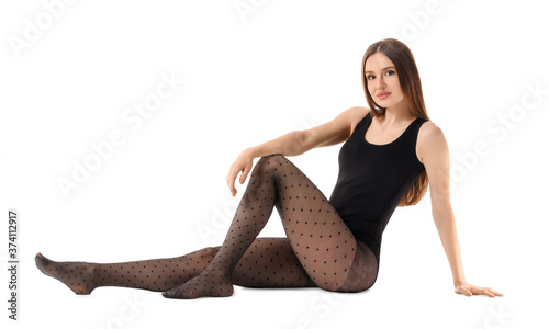 Beautiful young woman in tights on white background