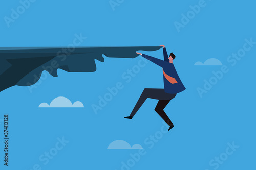 Business executive hanging on a cliff edge. Concept for business risks and challenges