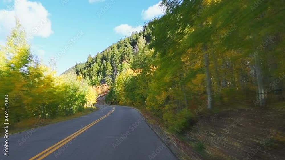 Slow motion front view car driving at Castle Creek scenic road with aspen trees in colorful autumn with vivid vibrant color foliage in Colorado Slow motion front view car driving at Castle Creek scenic road with aspen trees in colorful autumn with vivid vibrant color foliage in Colorado