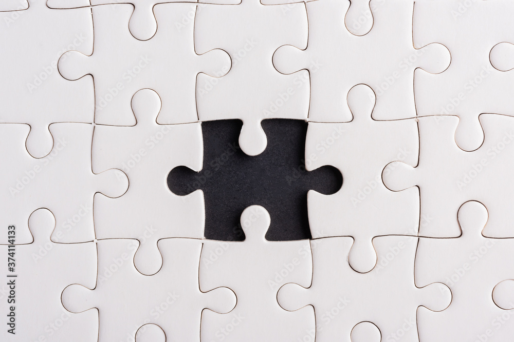 Top view flat lay of paper plain white jigsaw puzzle game texture incomplete or missing piece, studio shot on a black background, quiz calculation concept Top view flat lay of paper plain white jigsaw puzzle game texture incomplete or missing piece, studio shot on a black background, quiz calculation concept