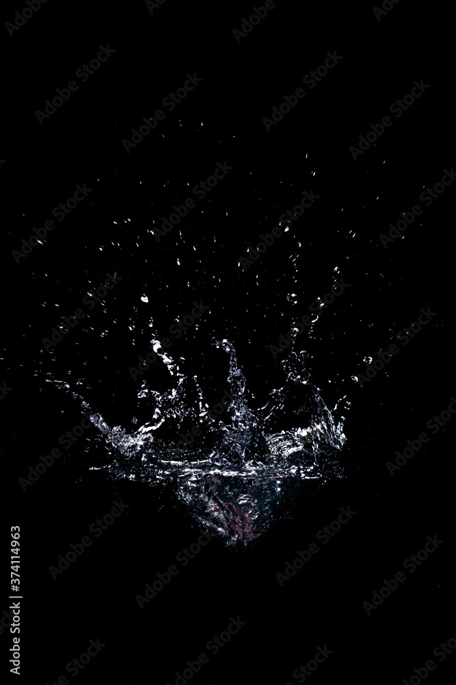 Clean water splash against black backdrop