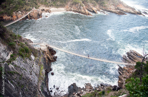 Suspended pedestrian bridges over the cliffs and bays in the Park Tsitsikama. photo