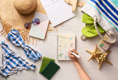 Woman making check-list of ...