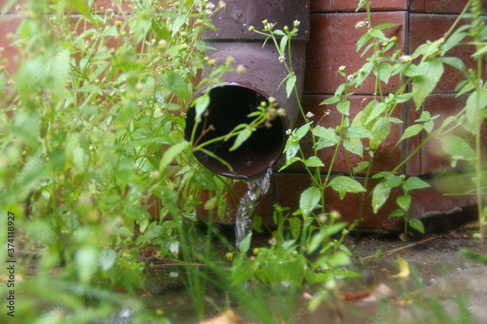 Water flows from the gutter after rain Water flows from the gutter after rain