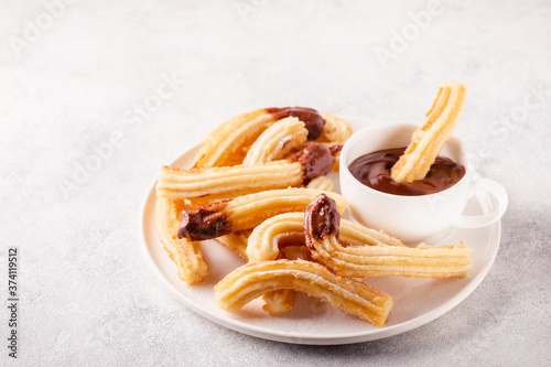 churros with powdered sugar and chocolate sauce