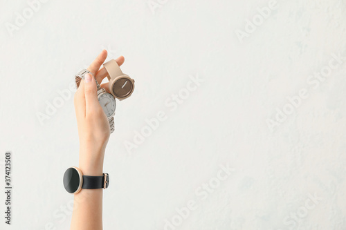 Photography Female hand with stylish wrist watches on white background