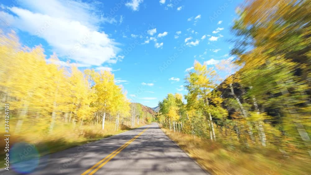 Front pov point of view driving car on Castle Creek scenic road in Aspen, Colorado USA Rocky mountains with colorful autumn fall foliage trees in 2019