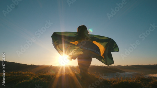 Brazilian Girl with National Flag at sunrise photo