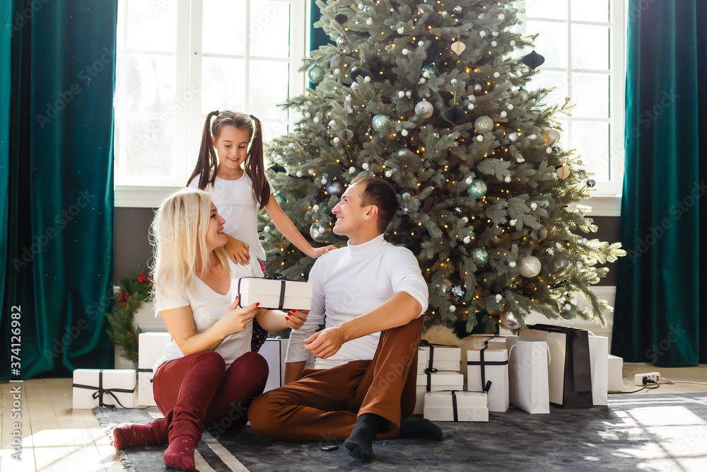 family, christmas, x-mas, winter, happiness and people concept - smiling family with many gift boxes