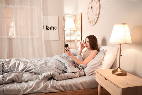 Stressed woman with alarm c...