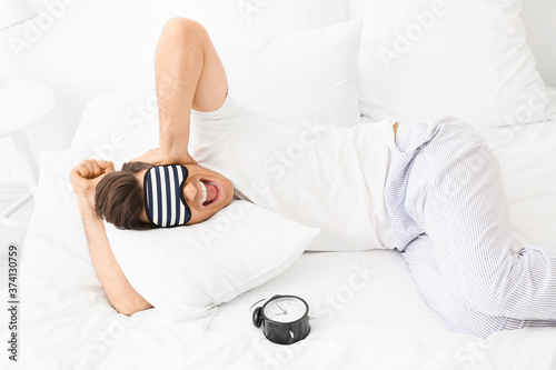 Stressed man with alarm clo...