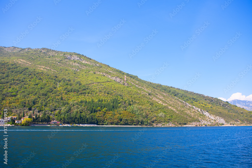 green coastal hill and blue sea 