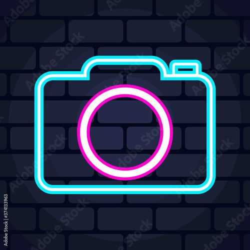 camera neon icon on brick wall