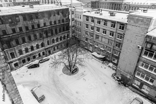 The courtyard of an old Soviet factory covered with snow photo