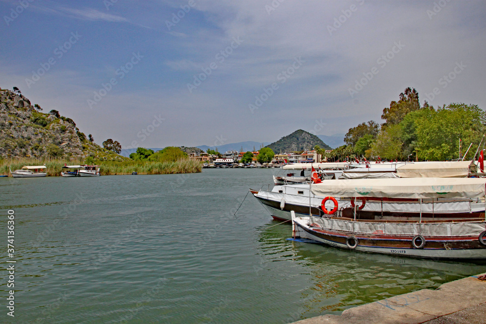 Vessels from the Dalyan Boat Cooperative moored by the side of the Dalyan River
