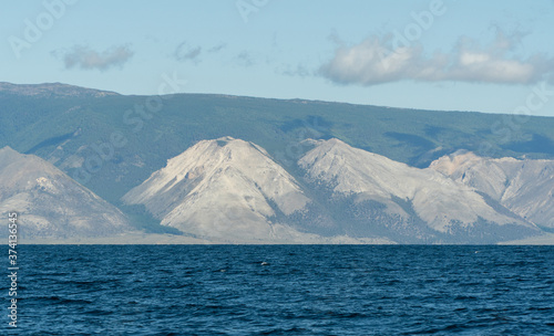Hill Stone face of Baikal. Guardian of the lake. rock near the shore, view from the water.