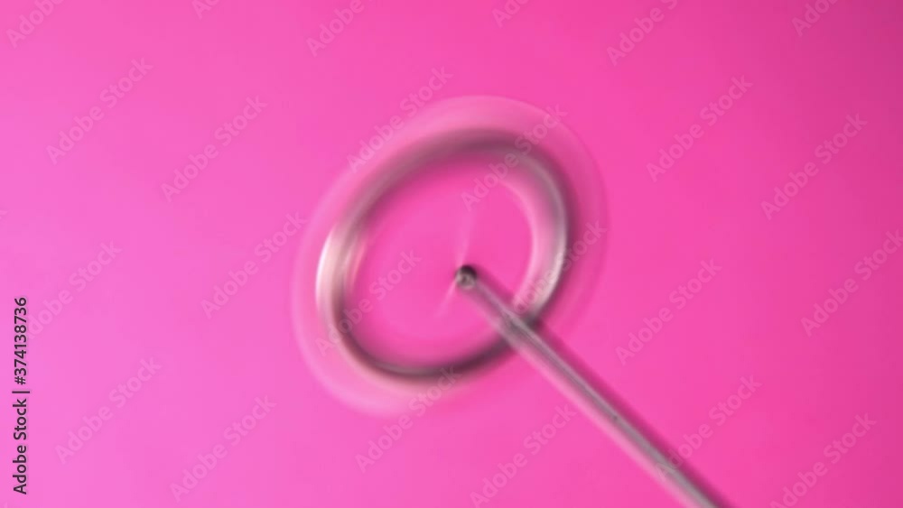 Milk frother spins on pink background slow motion Milk frother spins on pink background slow motion