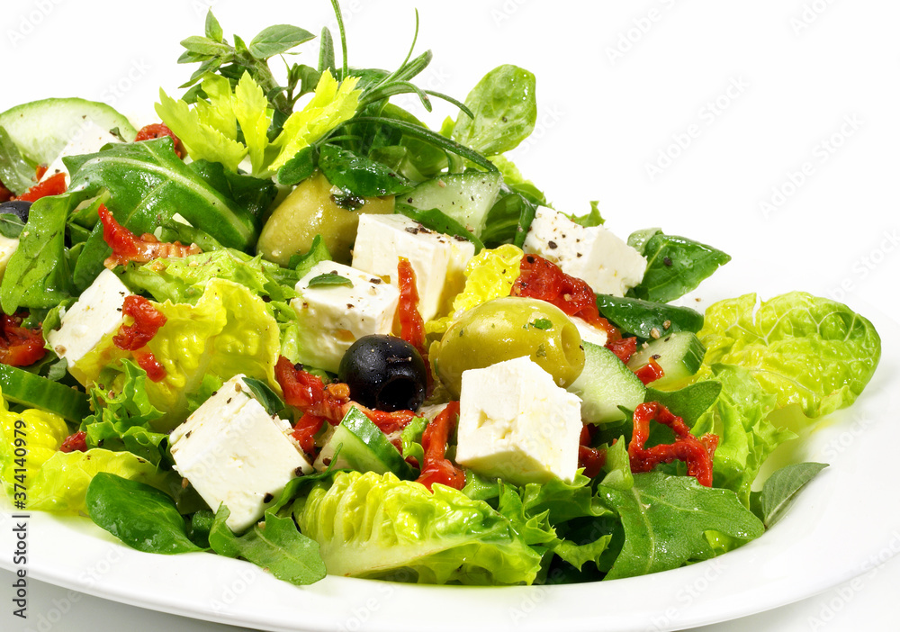 Mixed Salad with Feta Cheese, Olives and dried Tomatoes - Isolated on white Background Mixed Salad with Feta Cheese, Olives and dried Tomatoes - Isolated on white Background