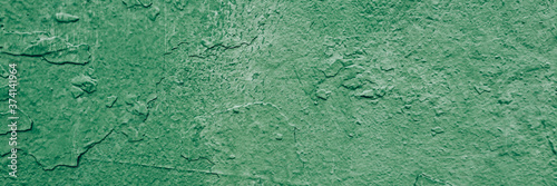 tectured old wall with a faded green paint