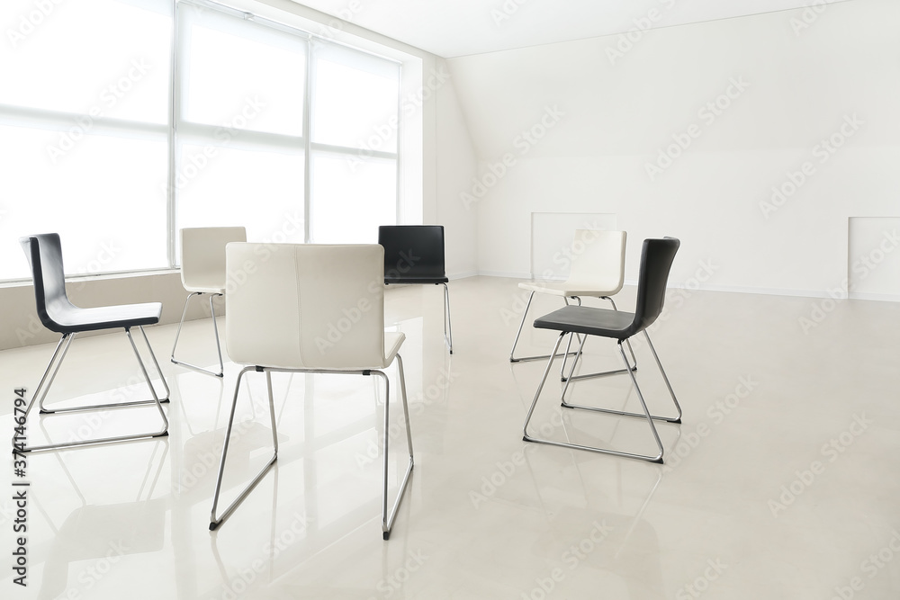 Empty chairs prepared for group therapy in psychologist's office