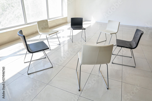 Empty chairs prepared for group therapy in psychologist's office