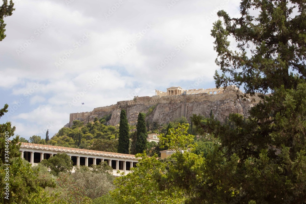 View trough vegetation of the Stoa of Atollos and Acropolis in Athens, Greece