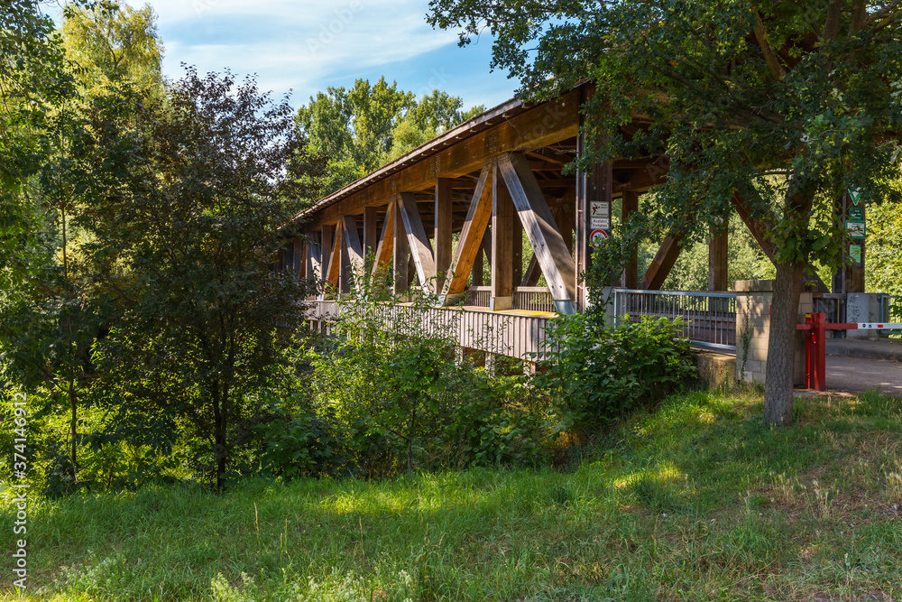 Fototapeta premium Old wooden bridge connecting natural reserve Rhine island in Ketsch, Germany