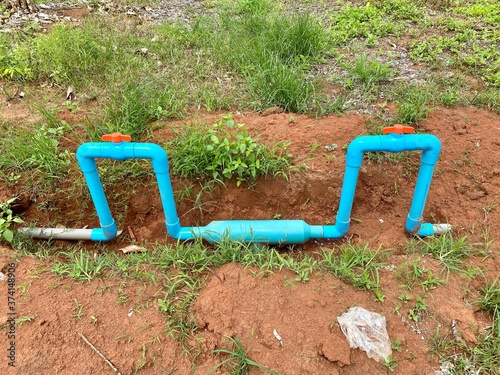dig the soil to lay the PVC water pipe in garden